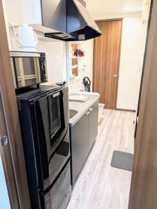 Kuchyň nebo kuchyňský kout v ubytování ランドリーデザインハウス