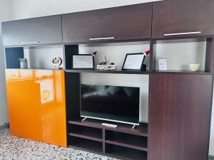 a entertainment center with a flat screen tv at Traiano 49 in Turin
