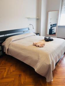 a bed with a blanket and a robe on it at Traiano 49 in Turin