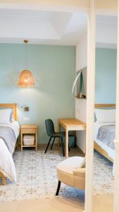 a bedroom with a bed and a desk at Palazzo Cettina Sul Mare in Cefalù