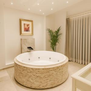 a large bathroom with a large tub in a room at Villa Ilda - Deluxe Holiday Villa - KALKAN-ANTALYA in Kalkan