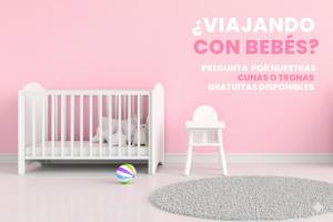 a pink room with a crib and a chair at Cabaña junto al Río y Montañas I AndBnB in Canillo