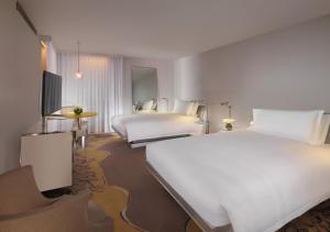 a hotel room with two beds and a television at Sanderson London in London +107 photos