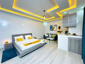 a bedroom with a large bed and a kitchen at VillAïda Gandon,Saint-Louis in Darou Rhamane