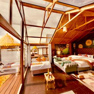 a large room with two beds in a boat at Hotel - Titicaca Dora in Puno