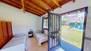 a room with a porch with a couch and a window at Casa Amplia 5 personas Con Pileta, Amplio Jardin y Parrilla Zona Muy Tranquila en Tigre Centro in Tigre +39 photos