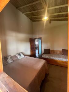a bedroom with two beds in a room at Casa Beira rio Caraíva in Porto Seguro +2 photos