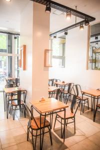 a row of tables and chairs in a restaurant at Casa Be Suites in Rosario