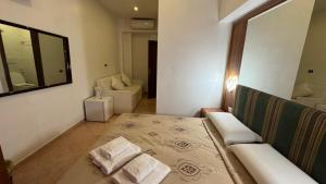 a room with a bed and a couch and a mirror at moonstar guesthouse termini in Rome