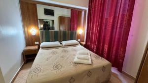 a bedroom with a bed with two towels on it at moonstar guesthouse termini in Rome +13 photos