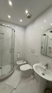 a bathroom with a shower and a toilet and a sink at moonstar guesthouse termini in Rome