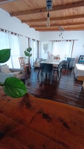 Una gran sala de estar con mesa y sillas. en Kiya surf hostel, en Colonia Chapadmalal