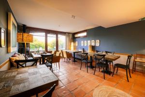 a restaurant with tables and chairs in a room at Hotel Barosse in Jaca