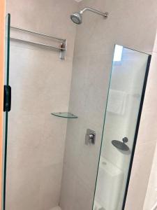 a shower with a glass door in a bathroom at Villas do Porto Residence by La Playa in Porto De Galinhas