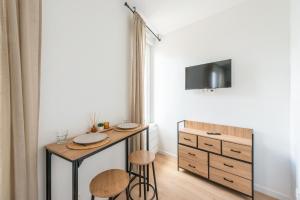 a kitchen with a table and stools in a room at Casa 159 - SAINT QUENTIN in Saint-Quentin