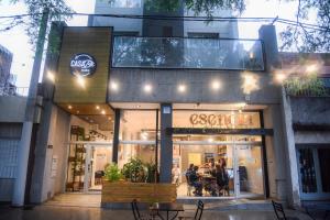 a store front of a store with tables and chairs at Casa Be Suites in Rosario