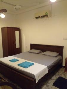 En eller flere senge i et værelse på Villa nelumalee