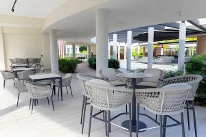 a patio with tables and chairs in a building at Panorama Lake in Punta Cana
