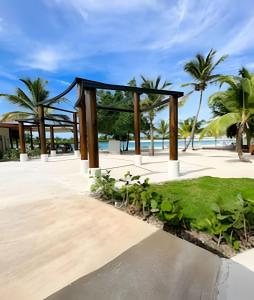 a pavilion at the beach with palm trees at Panorama Lake in Punta Cana