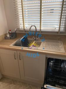 a kitchen counter with a sink with graffiti on it at Amblers Hide, Brigham, Cockermouth, Cumbria in Cockermouth +37 photos