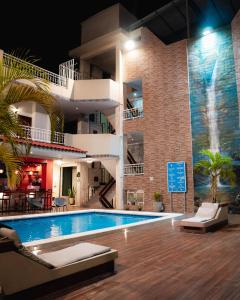 a pool in front of a building with a resort at Hotel Nilas in Tarapoto