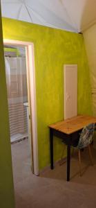 a table in a room with a green wall at Romantic Dome Escape in Saint-Martin in Saint Martin