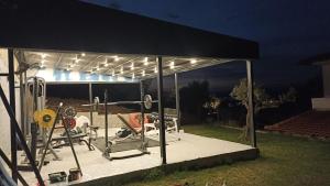 a gym with lights on it at night at Villa Dallas-Beach,Bike & Gym in Vourvourou