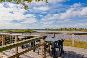 a table and chairs on a deck overlooking a river at The Ponce St. Augustine Hotel in Saint Augustine
