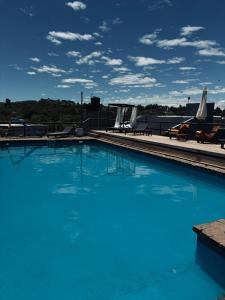 a large blue swimming pool on top of a building at Del valle cabañas in Tanti