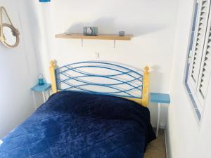 een slaapkamer met een bed met een blauw dekbed bij Shell's Apartment in Praia do Carvoeiro