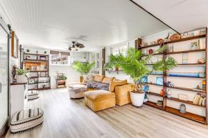 a living room filled with furniture and plants at Steps to Sand! Topsail Beach Group Getaway! in Surf City