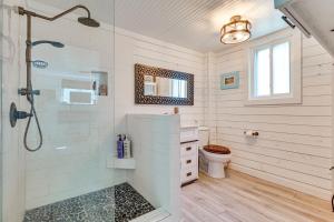 a bathroom with a shower and a toilet at Steps to Sand! Topsail Beach Group Getaway! in Surf City +37 photos