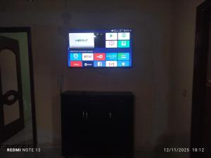 a flat screen tv hanging on a wall at App luxe riad zitoune in Meknès