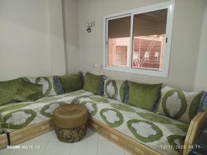 a living room with a couch and a window at App luxe riad zitoune in Meknès