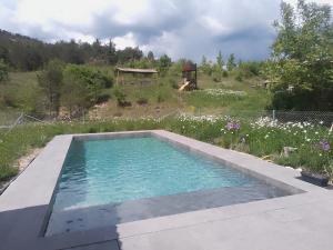 a swimming pool in the middle of a garden at La vie en Rosans - The upperhouse in Saint-André-de-Rosans