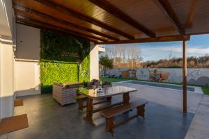 a patio with a table and a bench at La Villarina in Sitrama de Tera
