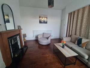 a living room with a couch and a table at Lovely four bed Roker house in Sunderland