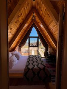 a bedroom with a bed in a room with a roof at Guest House Sara 2 in Žabljak