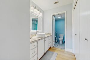 a white bathroom with a sink and a toilet at Horseshoe Bay Getaway in Horseshoe Bay +17 photos