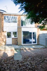 a house with a white door and windows at Ideal Home Away in Whitefield Bury in Manchester