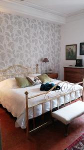 a bedroom with a large bed and a chair at Château Meilhen in Les Mages +39 photos