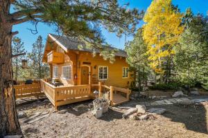 a log cabin in the woods with a large deck at CrazyHornChalet in Divide
