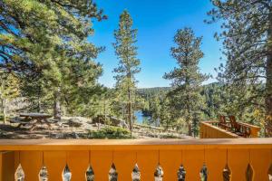 a deck with a view of a lake and trees at CrazyHornChalet in Divide