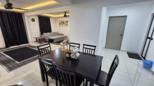 a dining table and chairs in a living room at SSHomestay in Skudai
