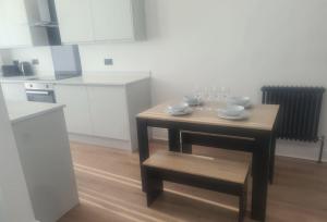 a small table in a kitchen with glasses on it at Modern one bed close to city in Sunderland