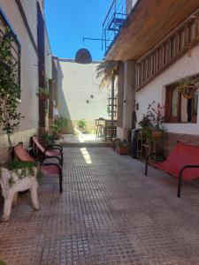 a group of benches sitting outside of a building at Suspiros De Mendoza in Barraquero