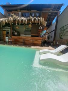 a swimming pool with water in front of a building at Suspiros De Mendoza in Barraquero +6 photos