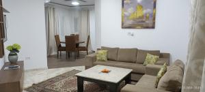 a living room with a couch and a table at TIM Haute standing appartment S2, center Monastir in Monastir