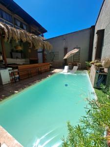 a swimming pool in the backyard of a house at Suspiros De Mendoza in Barraquero