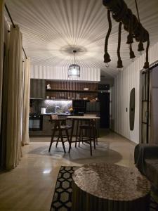 a living room with a table and a kitchen at Mimis Skyline in Xanthi